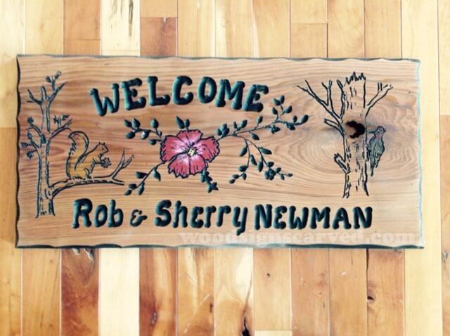 Rob and Sherry Newman - a custom carved cedar wood sign from Woodpecker Signs