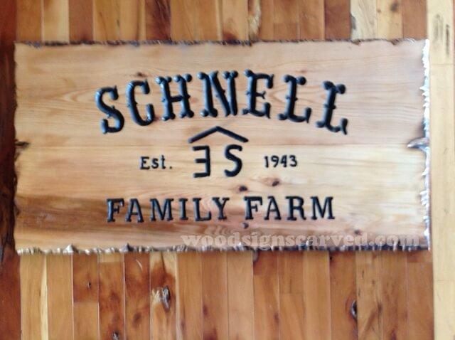 Schnell Family Farm - a custom carved cedar wood sign from Woodpecker Signs