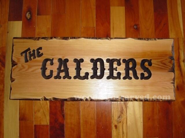 The Calders - a custom carved cedar wood sign from woodsignscarved.com